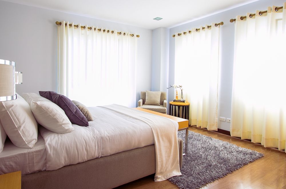 Sunlit clean bedroom with cozy decor